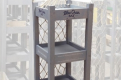 Blue Chair Bay Nautical Rack<br/>Wood shelf display rack with sails on top and netting on back